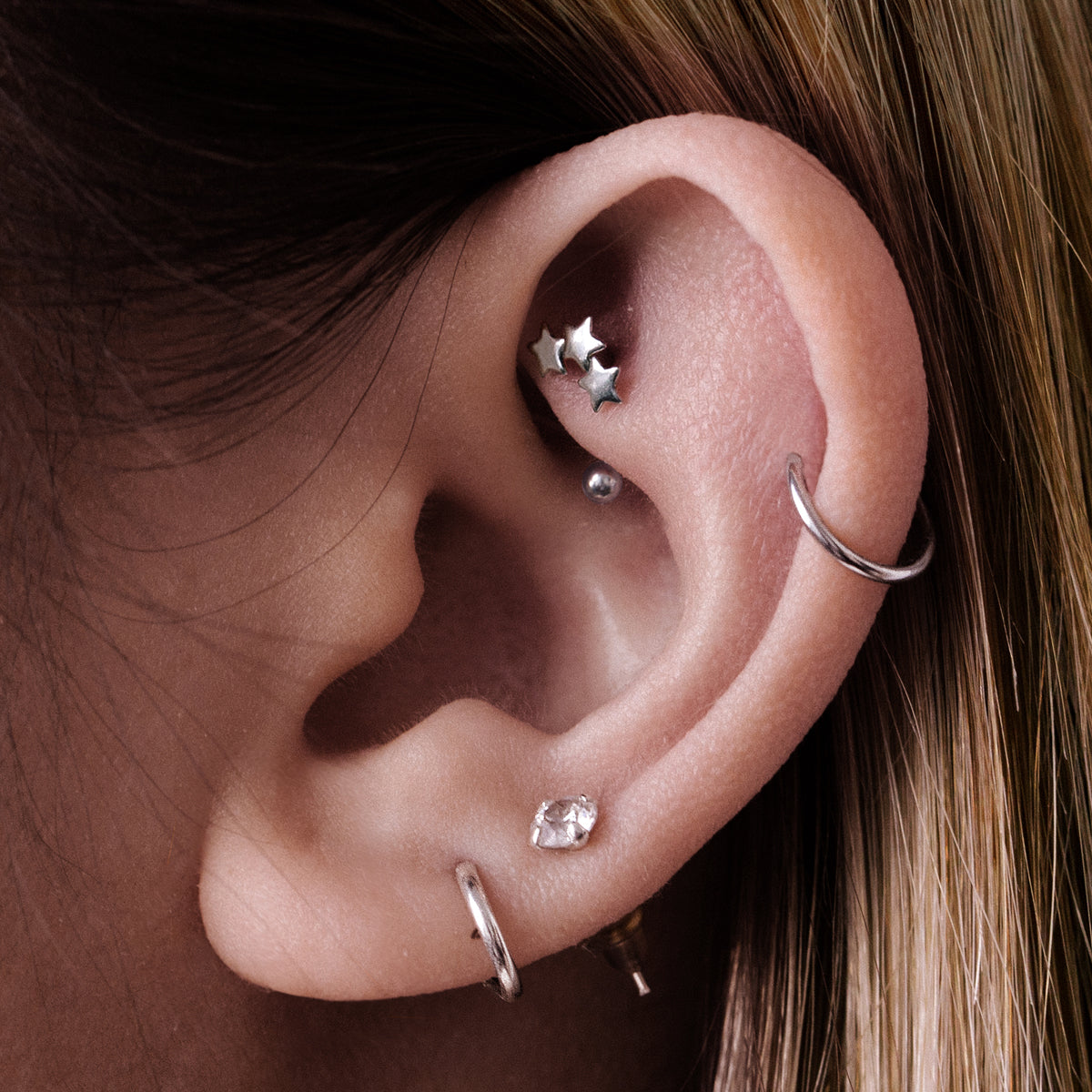 Stella Triple Star Rook Curved Barbell Piercing On Model - Silver
