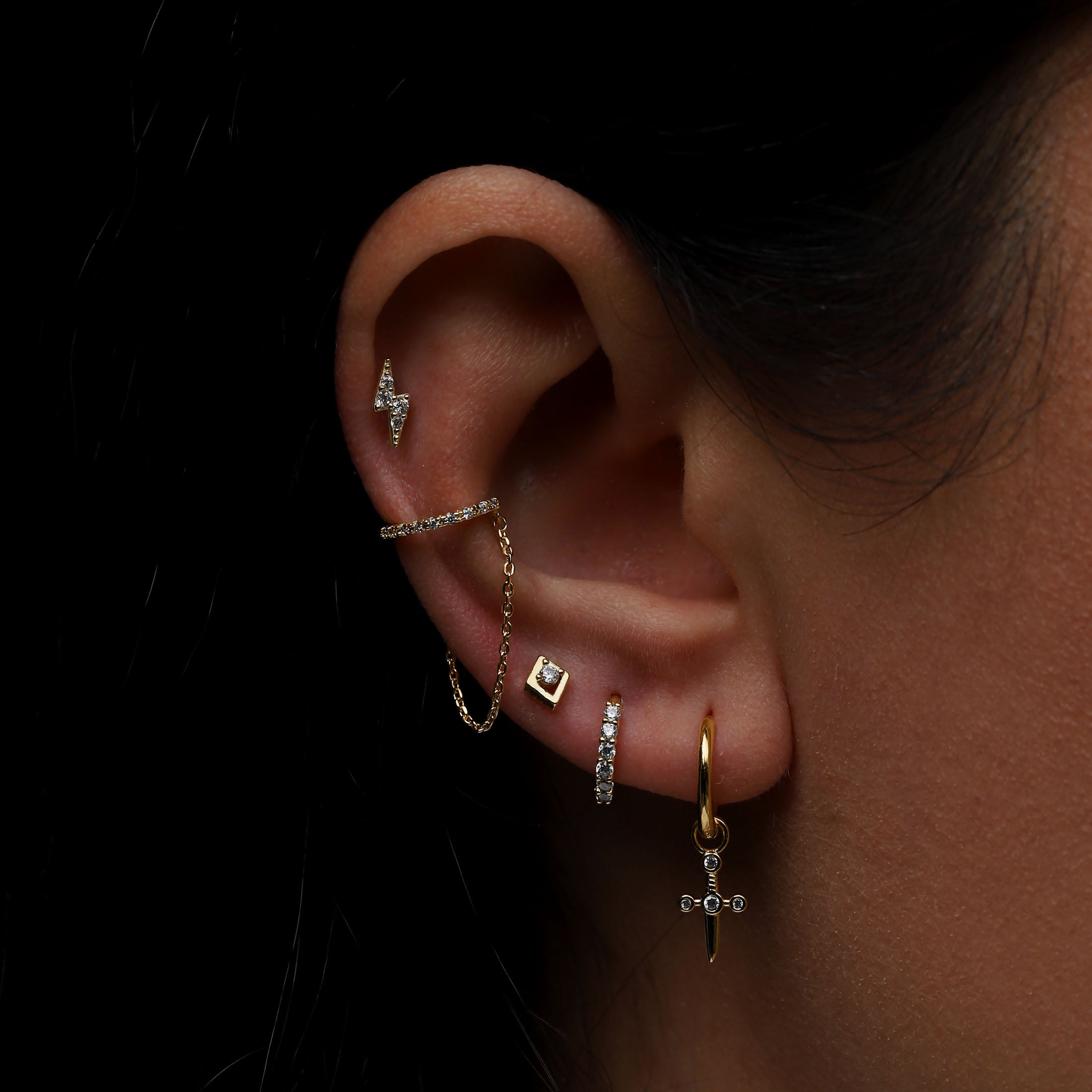 Dagger Charm Huggie Hoop Earrings On Model - Gold